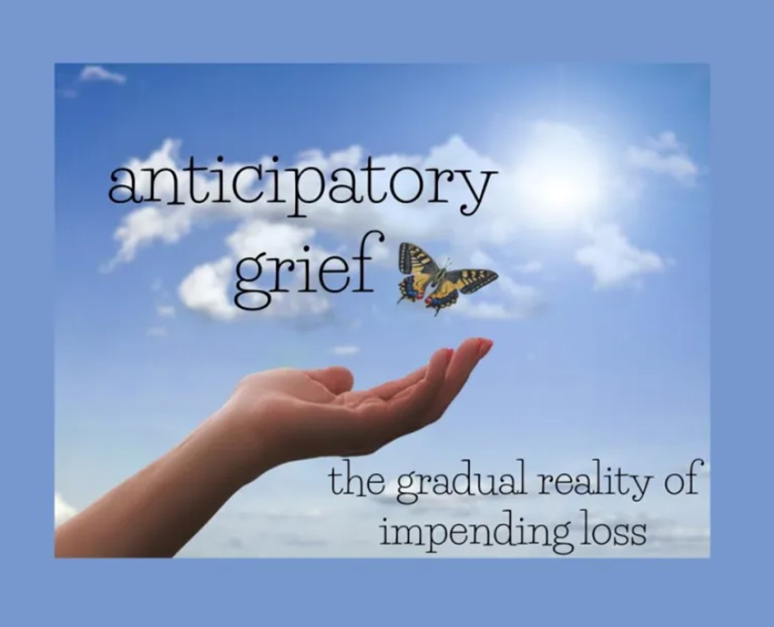 A hand is gently releasing a butterfly into a blue sky to illustrate this definition of anticipatory grief: "the gradual reality of impending loss."